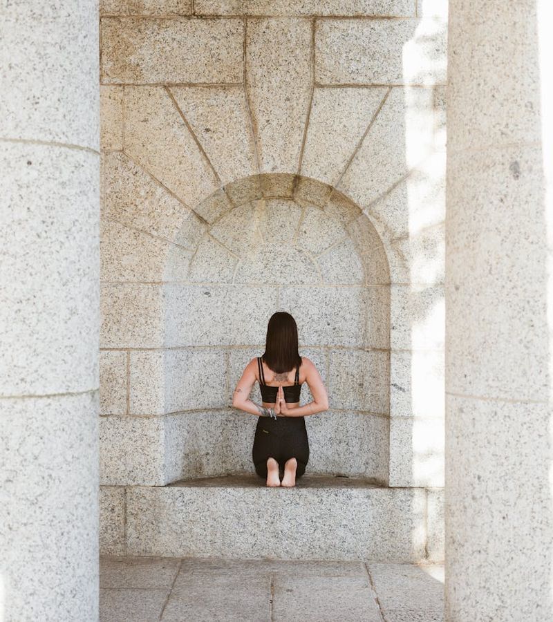 Woman in a calm, focused yoga pose symbolizing inner harmony and balance.
